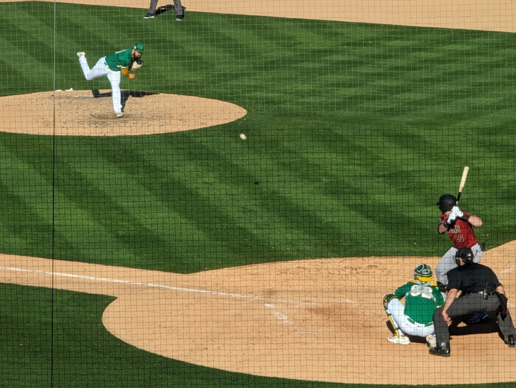 Rico Garcia of the Oakland Athletics pitches to Caleb Roberts of the Arizona Diamondbacks.