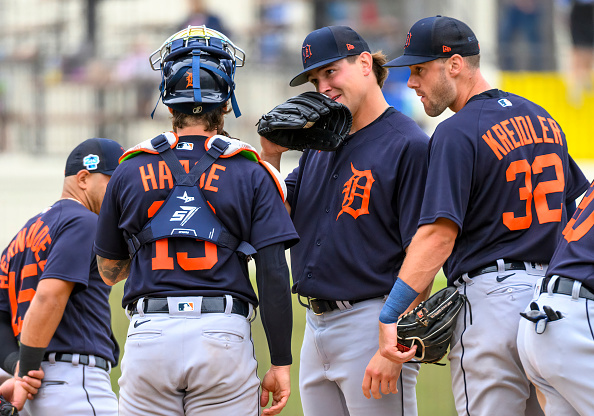 Members of the 2023 Detroit Tigers meeting on the mound during a spring training game