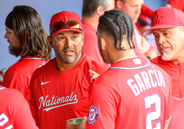 Dave Martinez instructing members of the 2023 Washington Nationals in the dugout during spring training