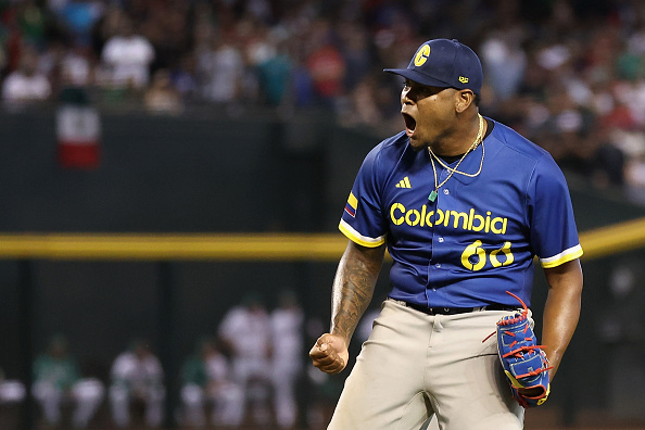 Colombia pitcher Guillermo Zuniga yelling in jubilee after recording the final out of his team's victory over Mexico.