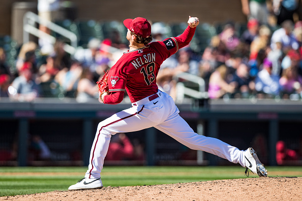 Ryne Nelson pitching for the Diamondbacks against the Rockies