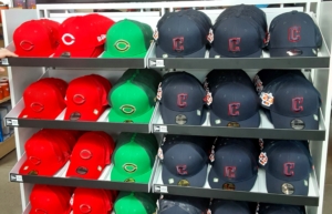 An Array of Cincinnati Reds and Cleveland Guardians hats - photo by Chuck Murr