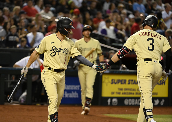 Corbin Carroll of the Diamondbacks congratulating teammate Evan Longoria after his home run against the Dodgers. Carroll was right about to hit a home run himself.