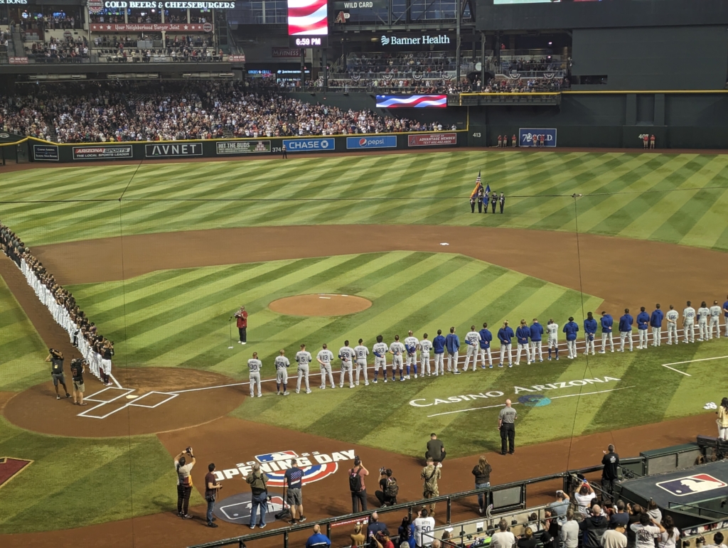 The Diamondbacks and Dodgers line up for the National Anthem after pregame festivities.