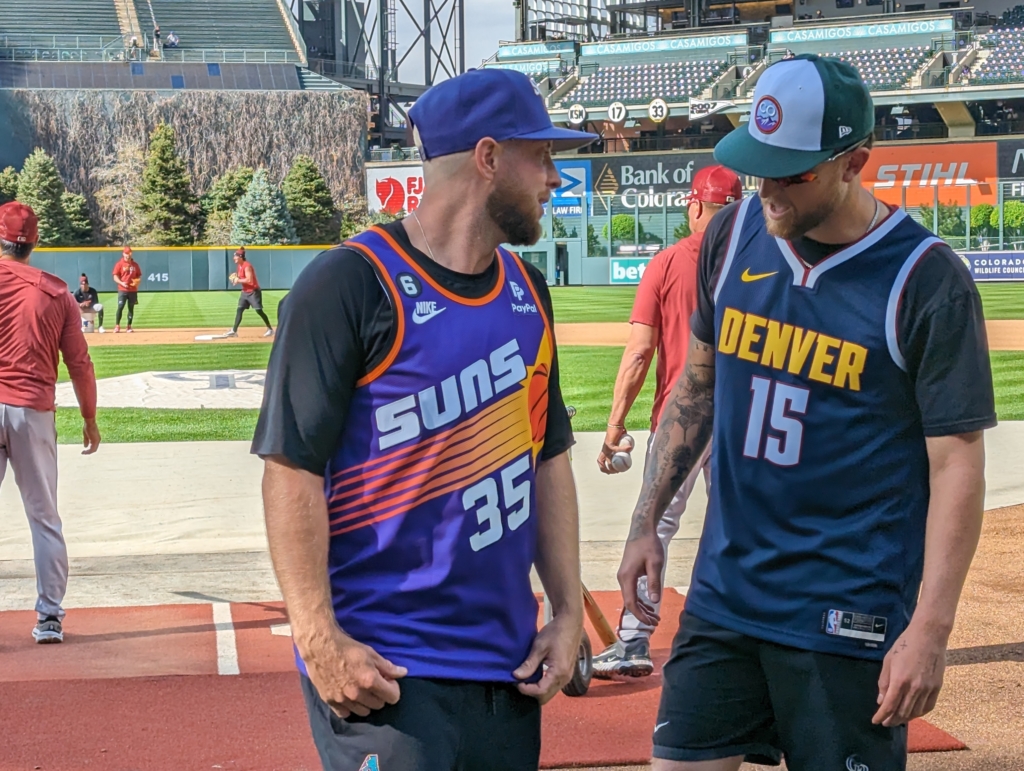 Merrill Kelly of the Diamondbacks and Kyle Freeland of the Rockies wearing Suns and Nuggets jerseys, respectively