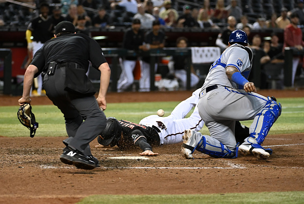 Christian Walker of the Diamondbacks diving in for the go-ahead run against the Royals.