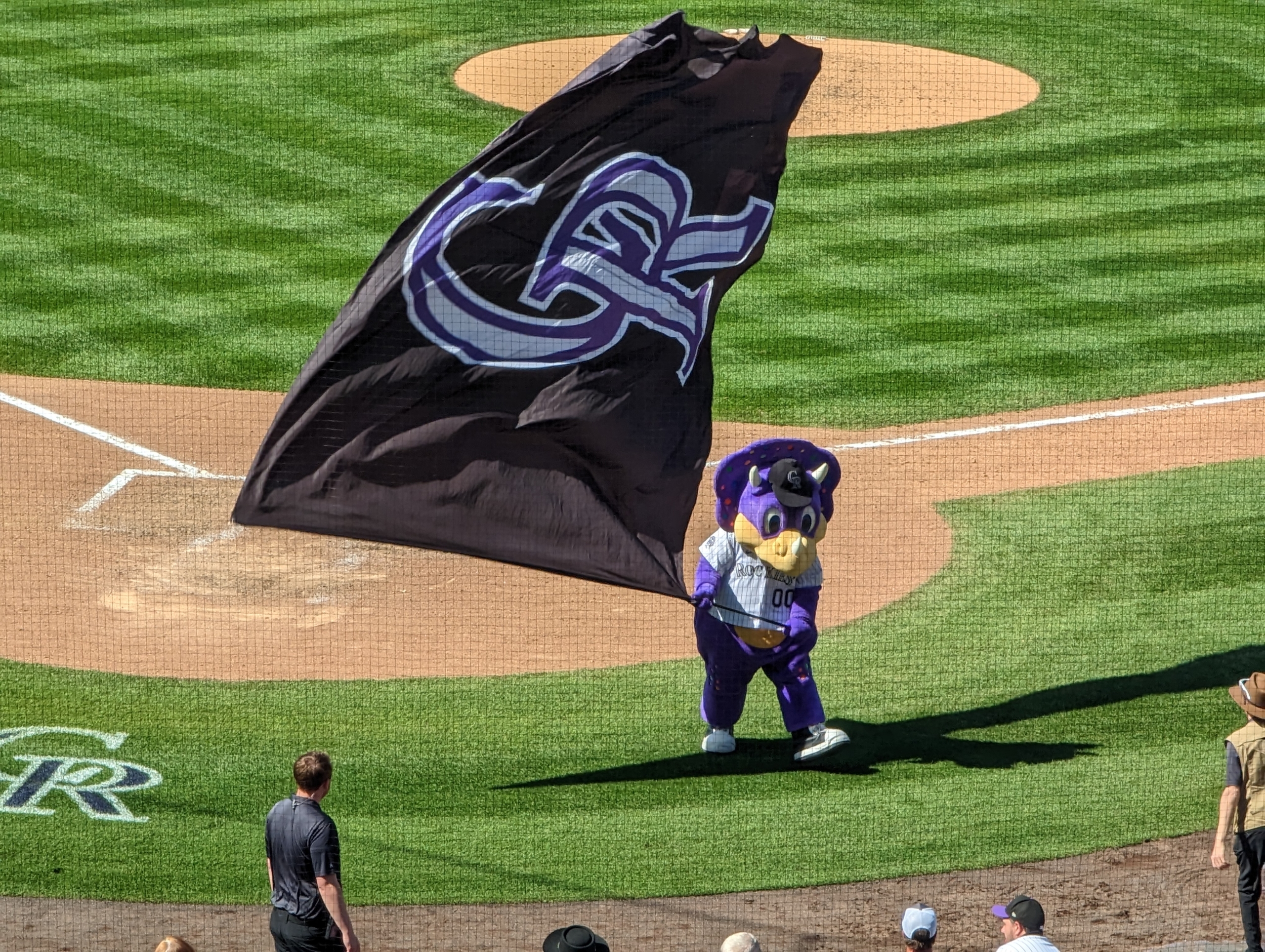 Dinger waves a victory flag after the Rockies defeated the Diamondbacks, 12–4.