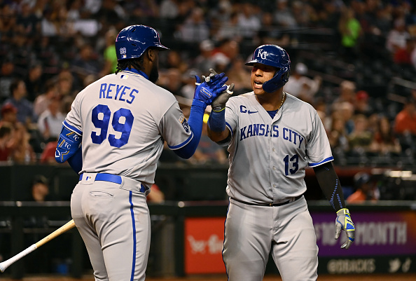 Salvador Perez and Franmil Reyes of the Royals celebrate a run against the Diamondbacks.