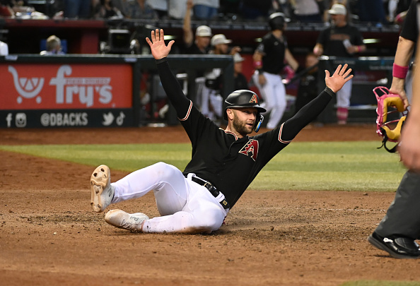 Christian Walker of the Diamondbacks celebrates after sliding home with the winning run against the Giants.