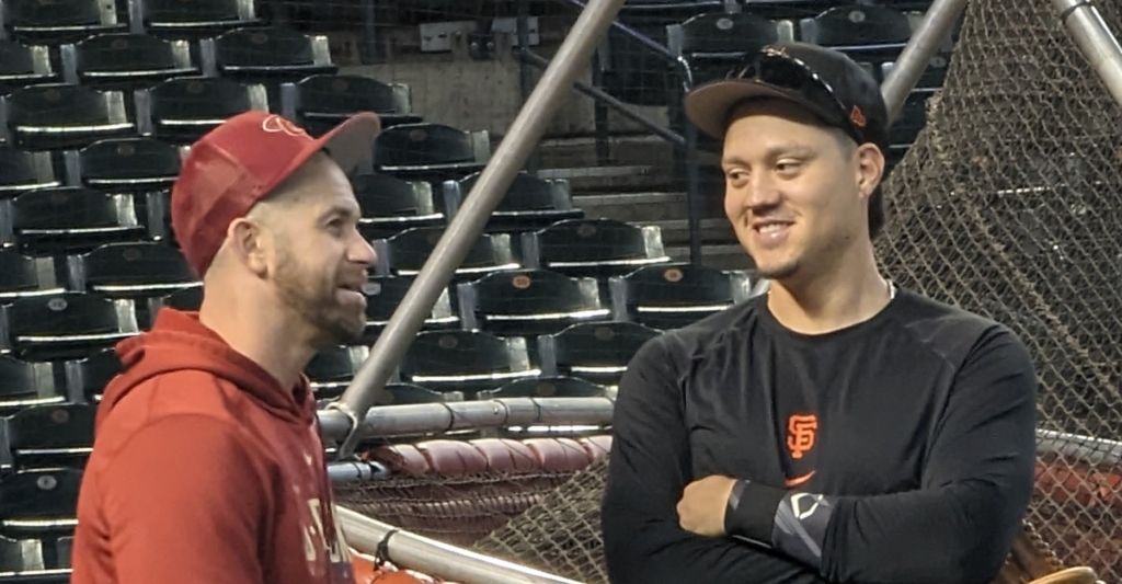 Evan Longoria of the Diamondbacks chatting with Wilmer Flores of the Giants prior to a game between the two teams.