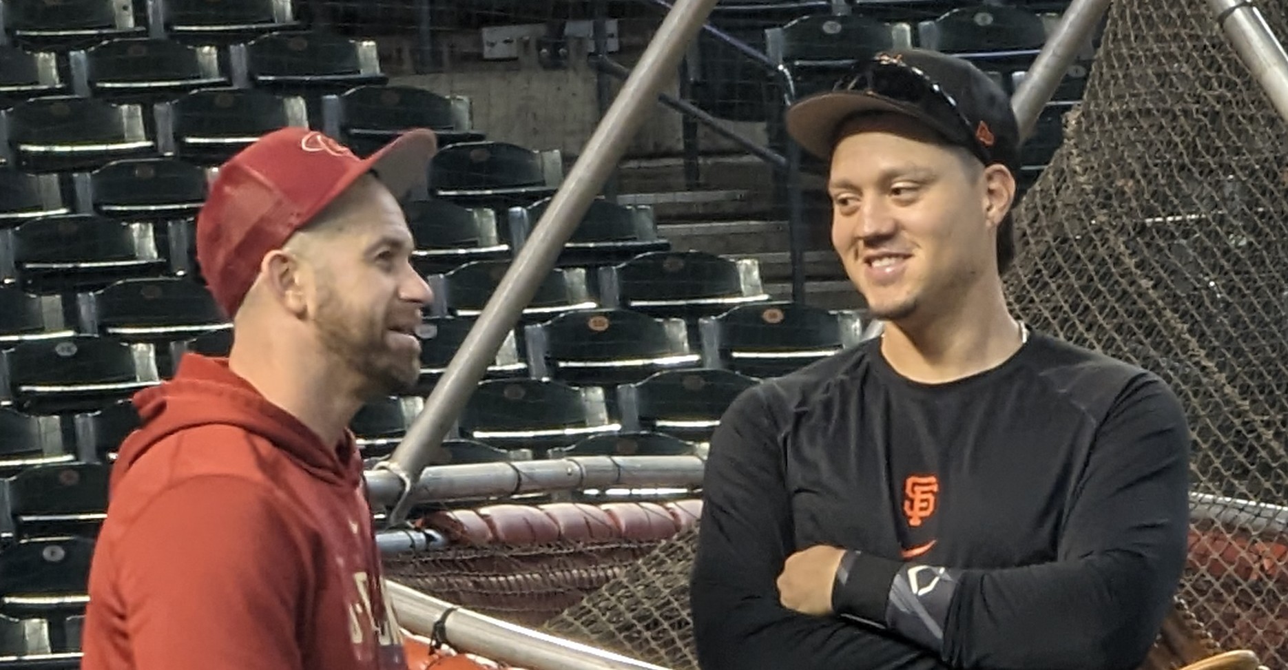 Evan Longoria of the Diamondbacks chatting with Wilmer Flores of the Giants prior to a game between the two teams.