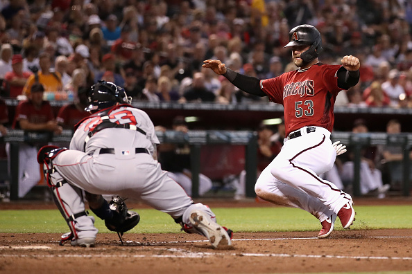Christian Walker of the Diamondbacks sliding in against the Red Sox. The Diamondbacks host the Red Sox after taking two of three from the Phillies on the road.