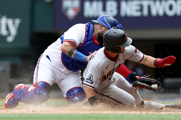 Dominc Fletcher of the Diamondbacks getting tagged out by Rangers catcher Sandy Leon.