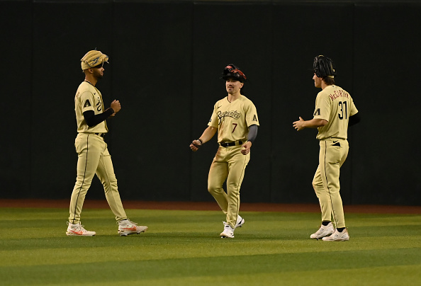 Diamondbacks outfielders celebrating a win over the Guardians