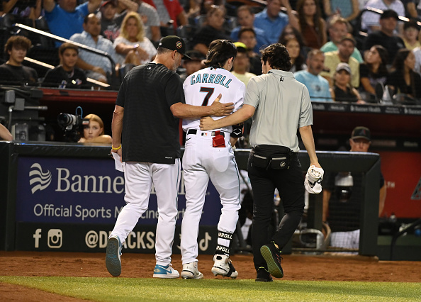 Corbin Carroll of the Arizona Diamondbacks being helped off the field after injuring his shoulder against the New York Mets.