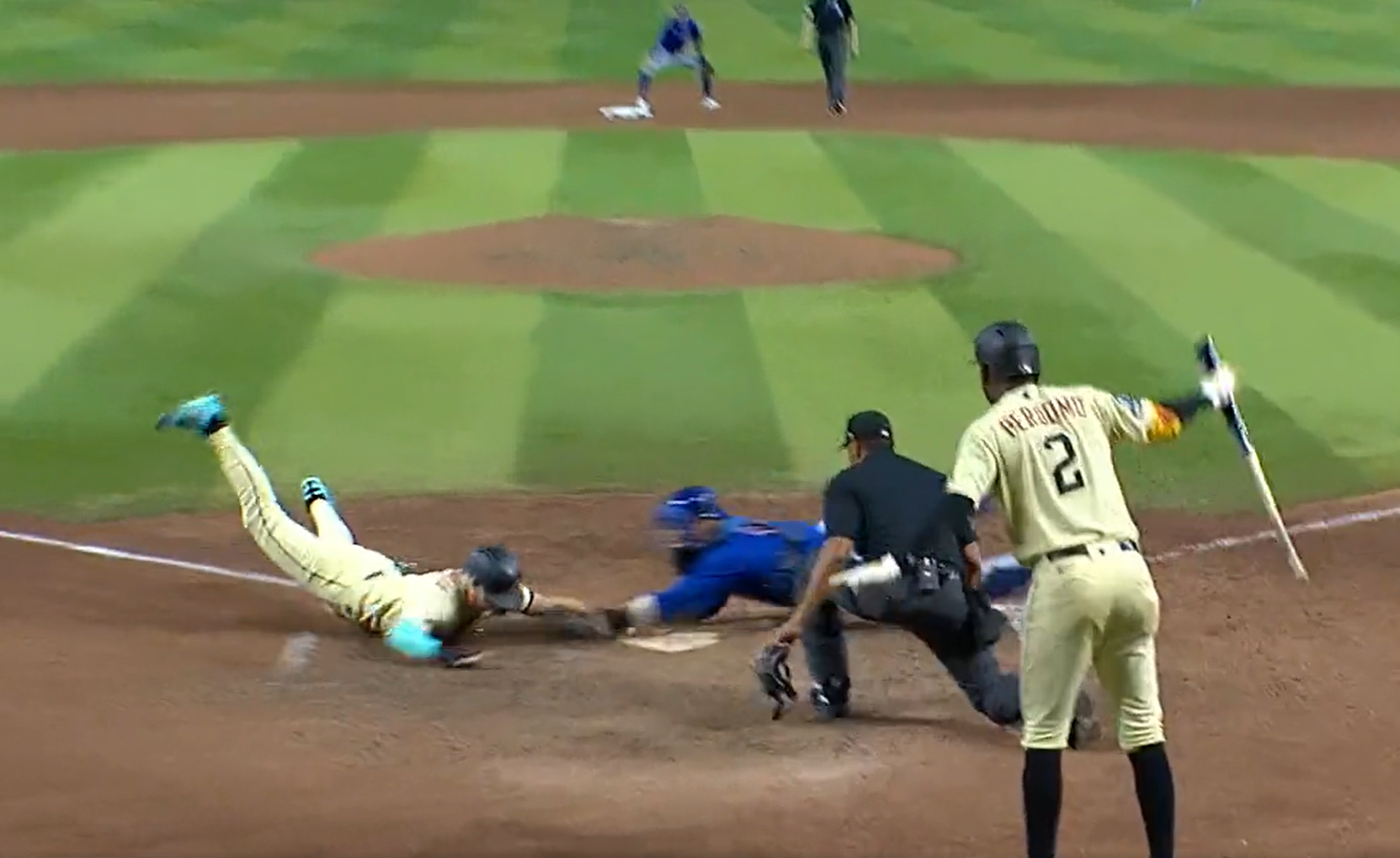 Evan Longoria of the Diamondbacks diving in with the winning run against the Chicago Cubs