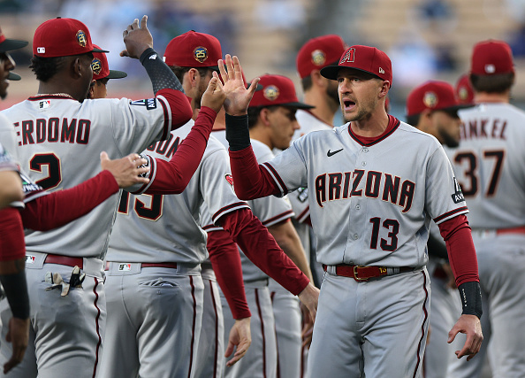 Shortstop Nick Ahmed slapping fives with teammates before a 2023 game against the Los Angeles Dodgers. Ahmed, the longest-tenured player in franchise history, was designated for assignment Wednesday afternoon.