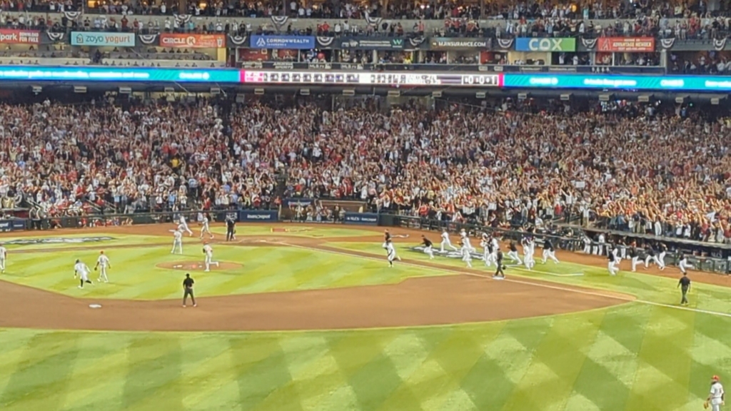 Diamondbacks players pouring onto the field to celebrate Ketel Marte's game-winning single in Game Three of the 2023 NLCS against the Phillies