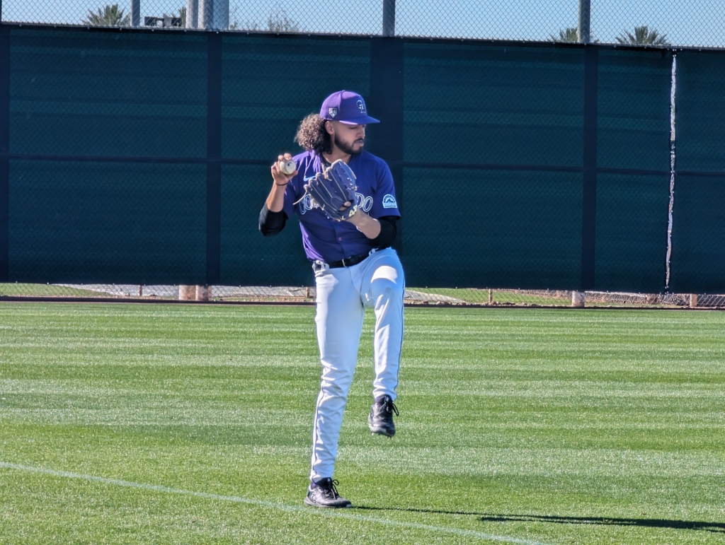 Justin Lawrence of the Colorado Rockies warming up prior to pitcher workouts.