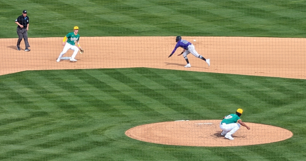 Aaron Schunk of the Rockies stealing second against the Athletics.