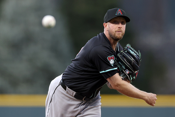 Merrill Kelly of the Diamondbacks throwing a pitch against the Rockies