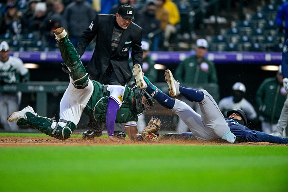 Rockies catcher Elias Diaz tags out Jonatan Clase of the Mariners