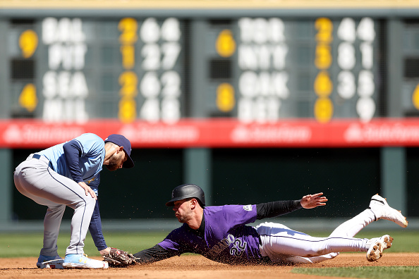 Jose Caballero of the Rays tagging out Nolan Jones of the Rockies