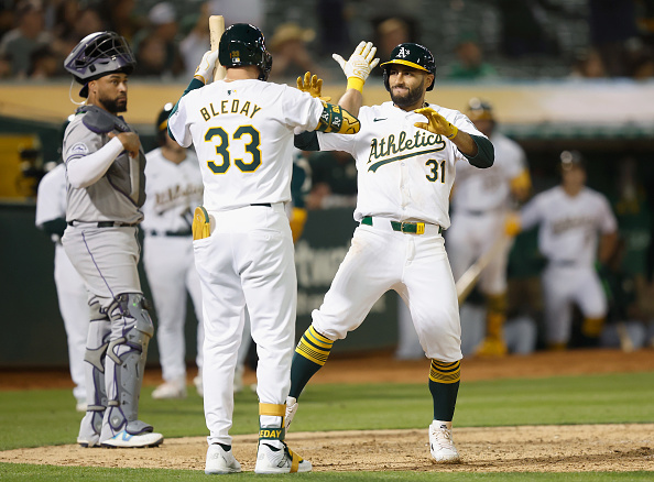 Abraham Toro and JJ Bleday of the Athletics celebrate Toro's home run against the Rockies