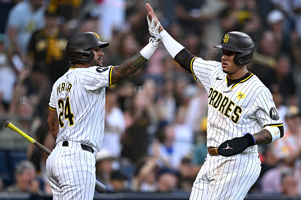 Manny Machado and David Peralta of the Padres celebrating a run against the Rockies