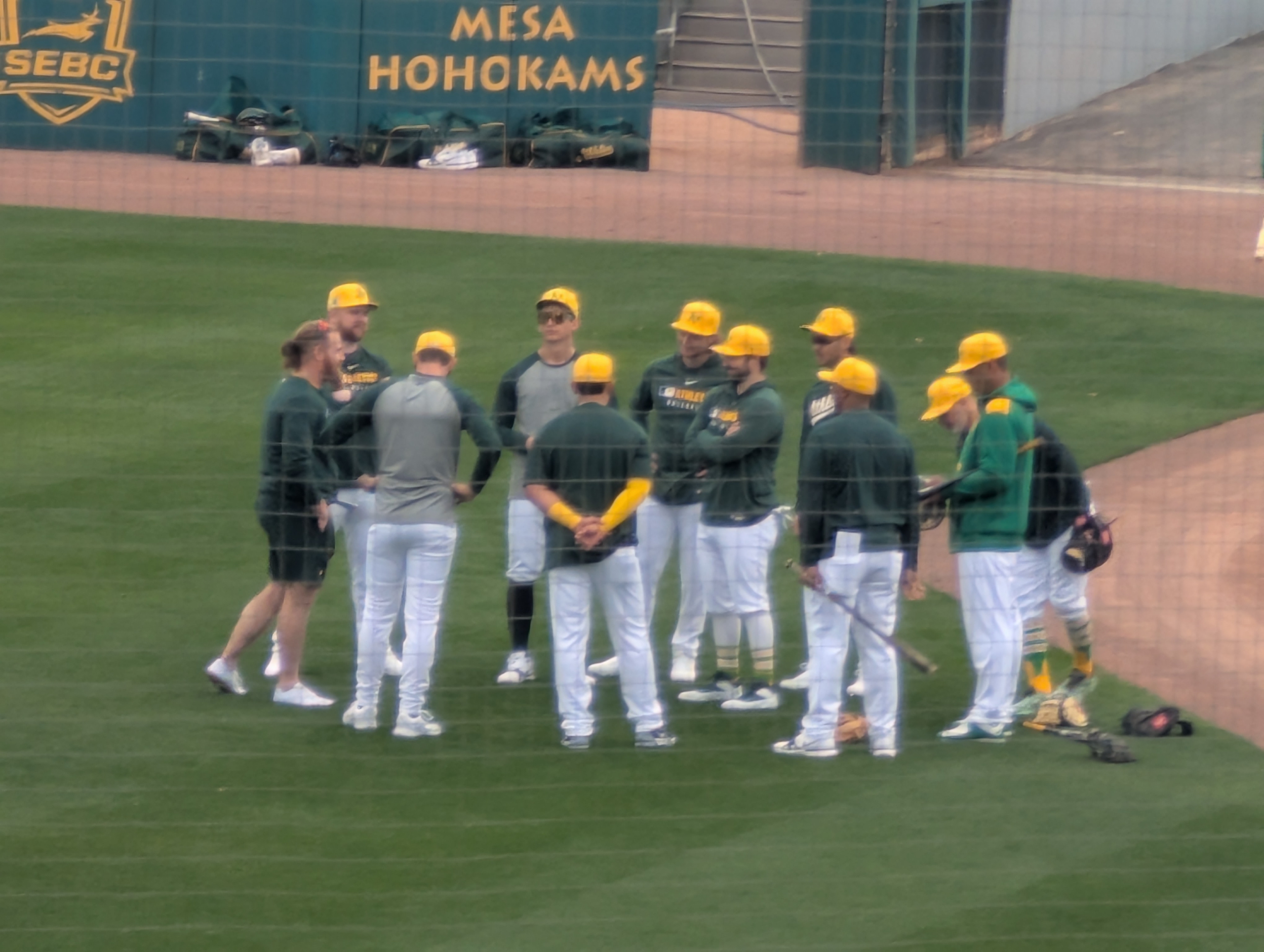 Mason Miller and other Athletics pitchers and catchers huddling up before the first day of workouts