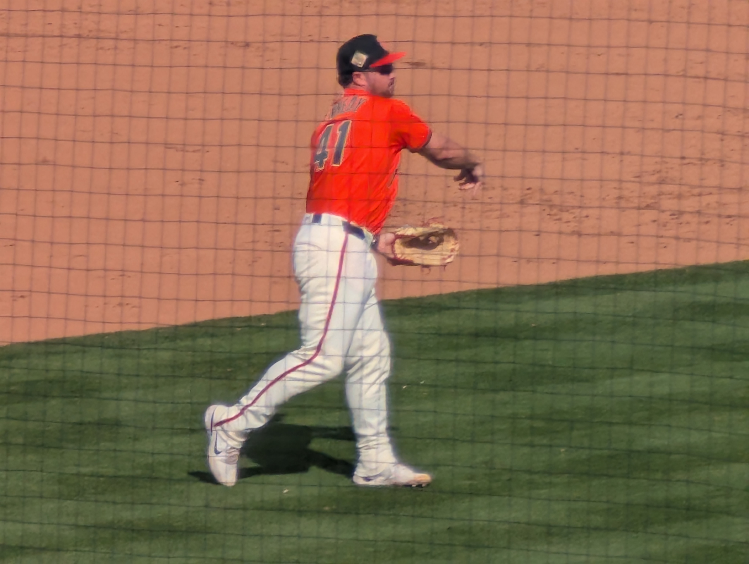 Buddy Kennedy, third baseman for the San Francisco Giants, throws to first while warming up between innings in spring training.