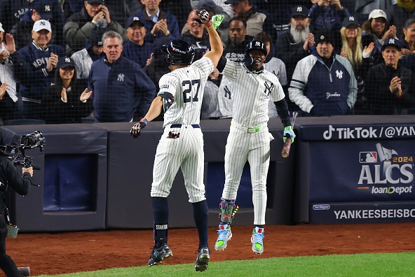 Two Yankees celebrating a win over the Guardians in Game One of the 2024 ALCS