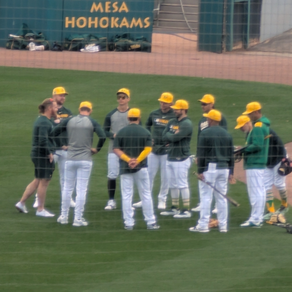 Mason Miller and other Athletics pitchers and catchers huddling up before the first day of workouts