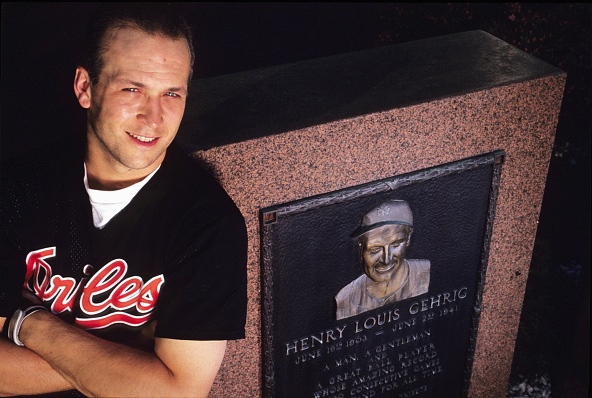 Cal Ripken leaning against Lou Gehrig's memorial in Monument Park at Yankee Stadium, 1990