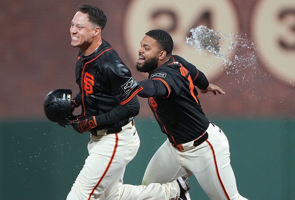 Wilmer Flores of the Giants celebrating after drawing the winning walk against the Athletics