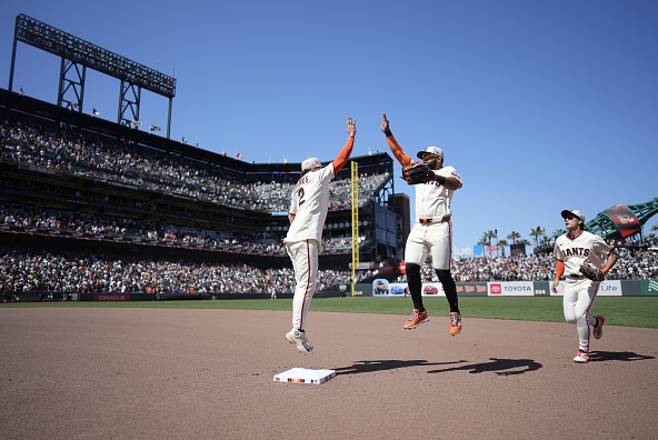 Two Giants celebrating a win over the Athletics