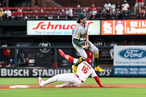 Jacob Wilson of the Athletics leaping after turning a double play against the Cardinals