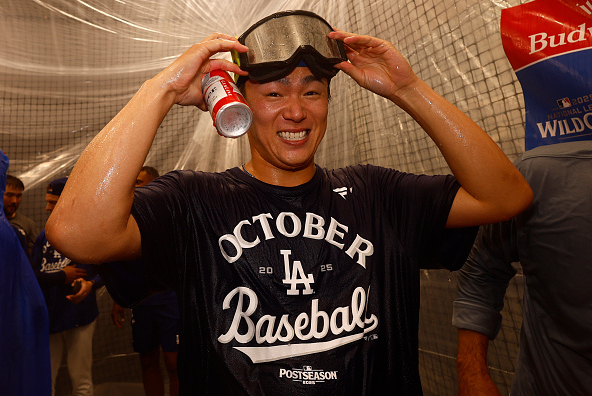 Yamamoto of the Dodgers celebrating in the clubhouse after his team's Wild Card series victory over the Reds