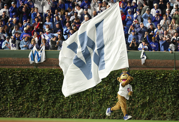 Clark, the Cubs mascot, runs the W flag on the field after the Cubs defeated the Brewers in Game Four of the 2025 NLDS