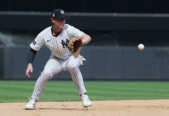 Ryan McMahon fielding a grounder. McMahon is one of two Yankees Gold Glove finalists.