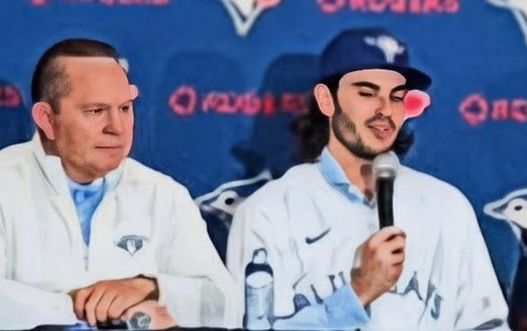 Dylan Cease and Scott Boras listen as reporters ask questions.