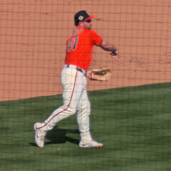 Buddy Kennedy, third baseman for the San Francisco Giants, throws to first while warming up between innings in spring training.