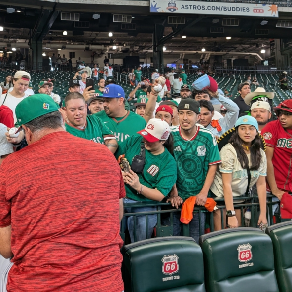 Team Mexico manager Benji Gil signing autographs for fans prior to his team's game against Great Britain at the 2026 World Baseball Classic