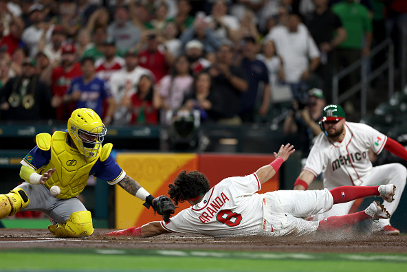 Jonathan Aranda sliding in with a run for Mexico in their 16–0 win over Brazil in the World Baseball Classic