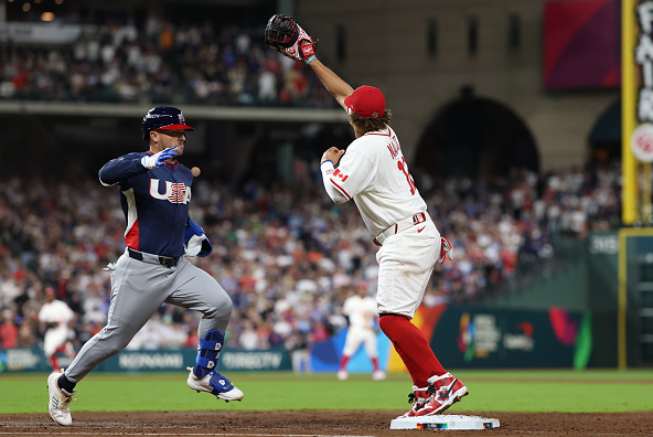 Alex Bregman of the United States beating out a grounder against Canada
