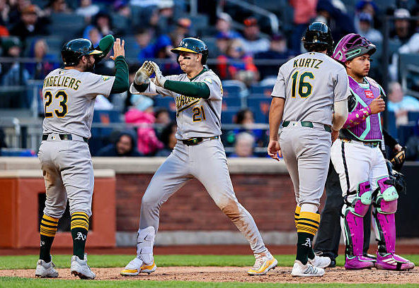 Tyler Soderstrom celebrating a homer with Athletics teammates Shea Langeliers and Nick Kurtz against the Mets