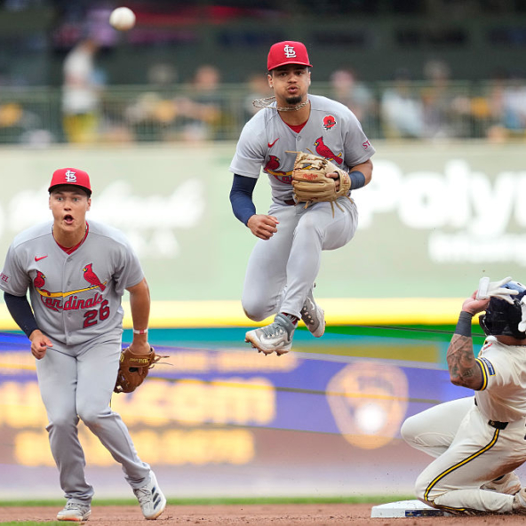 Masyn Winn of the Cardinals attempting to turn a double play against the Brewers
