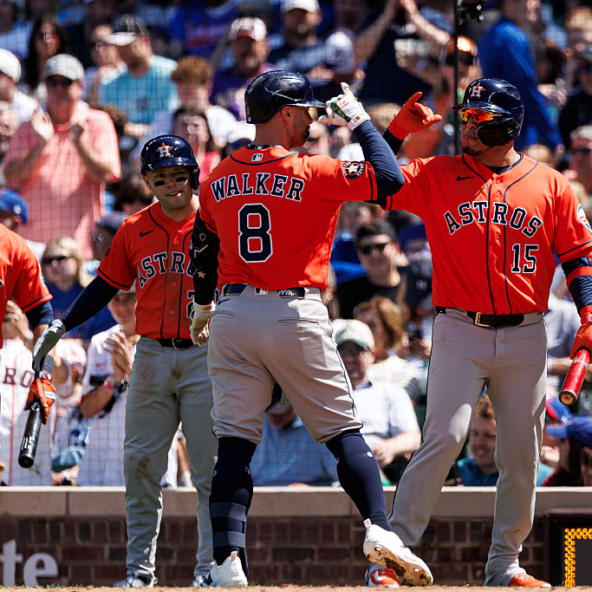 Christian Walker of the Astros celebrating with his teammates after hitting a homer against the Cubs
