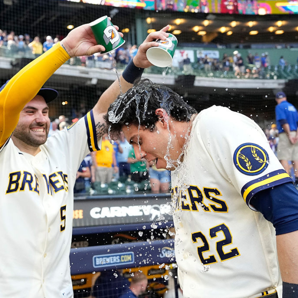 Garrett Mitchell and Christian Yelich of the Brewers celebrating a win against the Cardinals