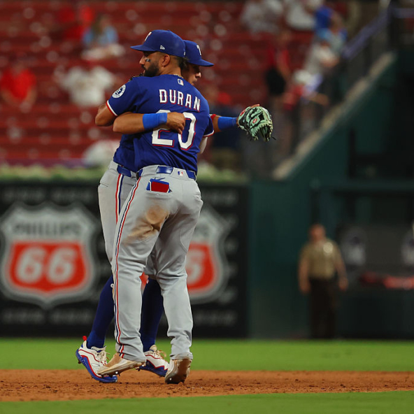 Rangers players celebrating a victory over the Cardinals